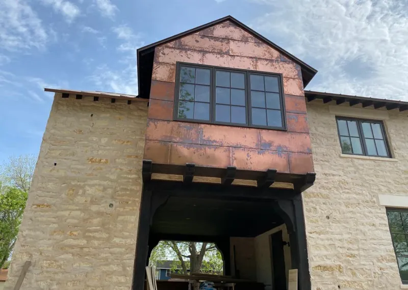 Copper metal panel facade on a stone building for Skylight Installation in Carlinville